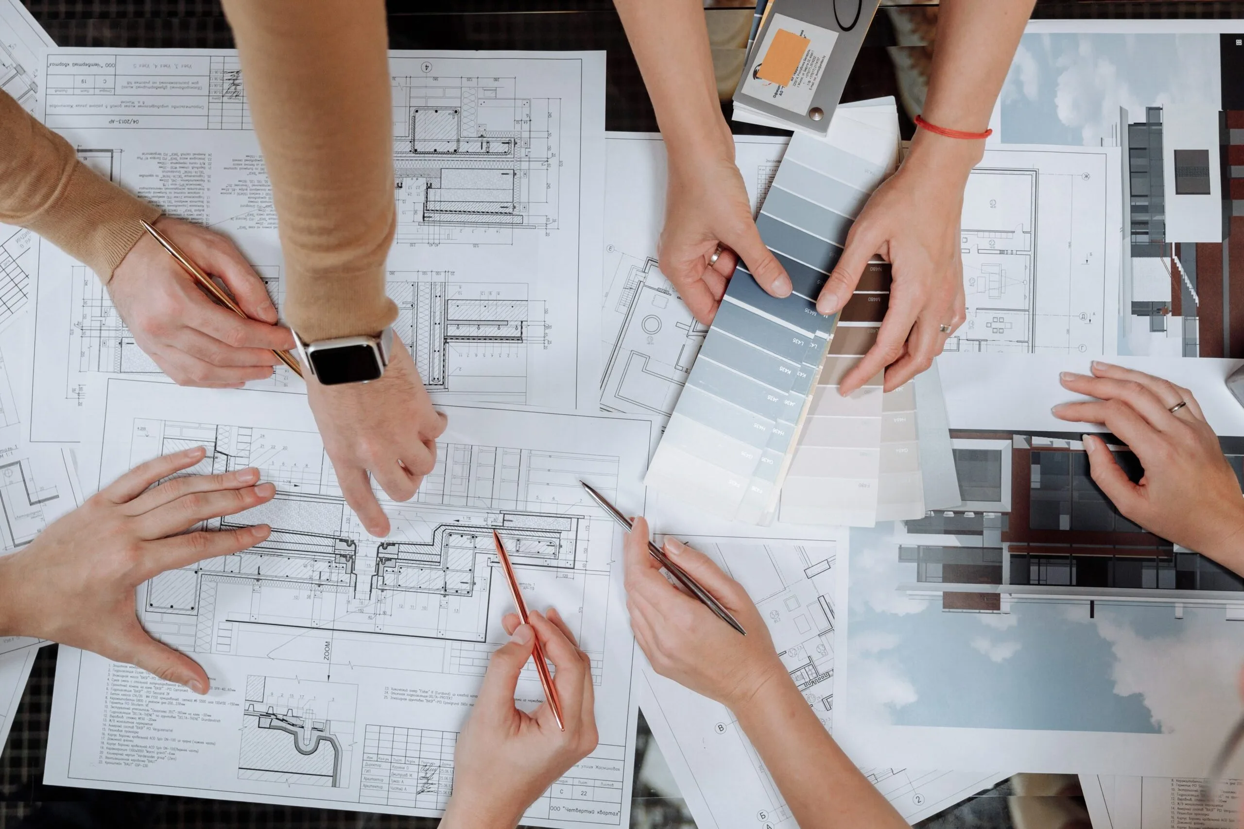 Sales team reviewing planning documents and specifications